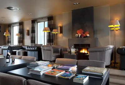 a living room with a table and chairs and a fireplace at Fletcher Hotel - Restaurant Nautisch Kwartier in Huizen
