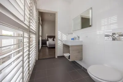 a bathroom with a toilet and a sink and a mirror at Fletcher Hotel - Restaurant Nautisch Kwartier in Huizen