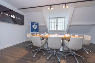 a conference room with a wooden table and chairs at Fletcher Hotel - Restaurant Nautisch Kwartier in Huizen