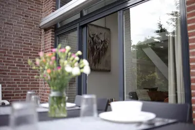a vase of flowers sitting on top of a table at At the Dunes in Egmond aan den Hoef