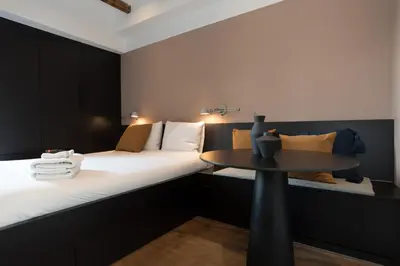 a small room with a bed and a table at City centre studio canal belt in Amsterdam