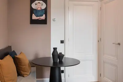 a table with two vases on it in a room at City centre studio canal belt in Amsterdam