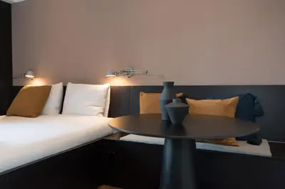 a room with a bed and a table in front of it at City centre studio canal belt in Amsterdam
