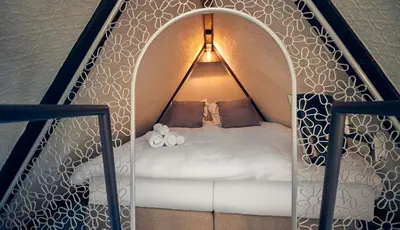 a bedroom with a bed in a room with a wall at HUISJES AAN DE AMSTEL - Your home away from home in Amstelveen