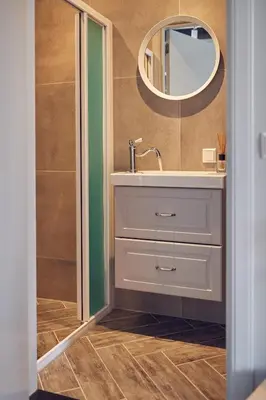 a bathroom with a sink and a mirror at HUISJES AAN DE AMSTEL - Your home away from home in Amstelveen