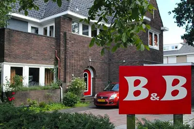 a red and white sign in front of a house at Xaviera's Bed and Breakfast in Amsterdam