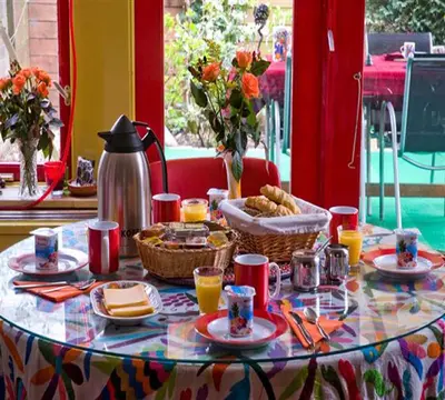 a table with food and drinks on top of it at Xaviera's Bed and Breakfast in Amsterdam