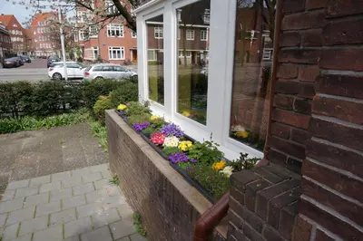 a window box with flowers on the side of a house at Xaviera's Bed and Breakfast in Amsterdam