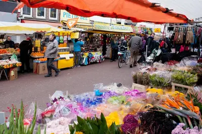 a group of people walking around a market with flowers at Xaviera's Bed and Breakfast in Amsterdam