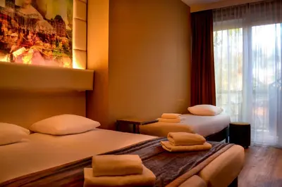 a hotel room with two beds and a window at Hotel Mosaic City Centre in Amsterdam