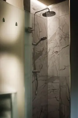 a bathroom with a shower with a glass door at Boutique Hotel Villa Kranenbergh in Bergen