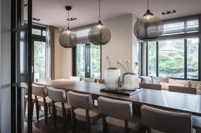 a dining room with a table and chairs at Boutique Hotel Villa Kranenbergh in Bergen
