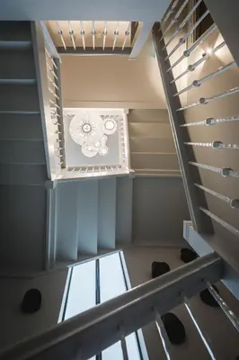 a spiral staircase in a house with a window at Boutique Hotel Villa Kranenbergh in Bergen