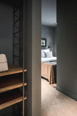 a bedroom with a bed and a book shelf at Boutique Hotel Villa Kranenbergh in Bergen