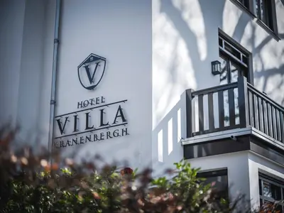 a sign on the side of a building at Boutique Hotel Villa Kranenbergh in Bergen