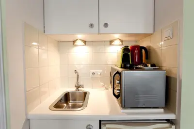 a small kitchen with a sink and a microwave at Sunflower Amsterdam in Amsterdam