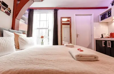 a bedroom with a large bed with towels on it at Sunflower Amsterdam in Amsterdam