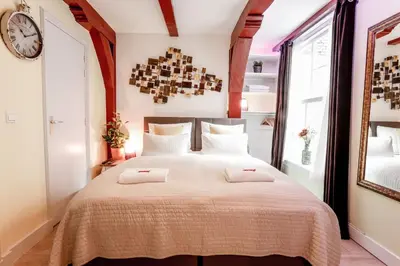 a bedroom with a large bed with two towels on it at Sunflower Amsterdam in Amsterdam
