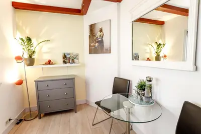 a dining room with a glass table and chairs at Sunflower Amsterdam in Amsterdam