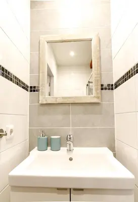 a bathroom with a white sink and a mirror at Sunflower Amsterdam in Amsterdam