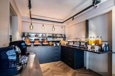 a large kitchen with a counter with food on it at Hotel Atlantis Amsterdam in Amsterdam