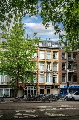 a large building with bikes parked in front of it at Hotel Atlantis Amsterdam in Amsterdam