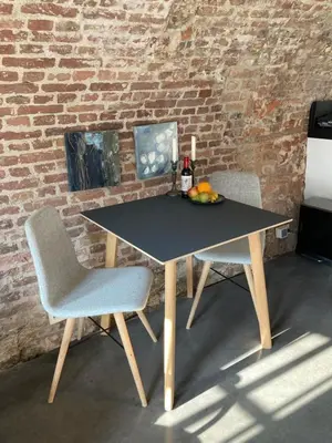 a table and two chairs with a bowl of fruit on it at De Hoendervorst in Utrecht
