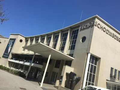 a building with a sign on the front of it at De Hoendervorst in Utrecht