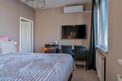 a bedroom with a bed and a table with chairs at Liv Inn Hillegom in Hillegom