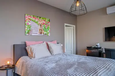 a bedroom with a bed and a painting on the wall at Liv Inn Hillegom in Hillegom