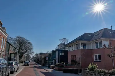a street with houses and cars parked on the street at Liv Inn Hillegom in Hillegom