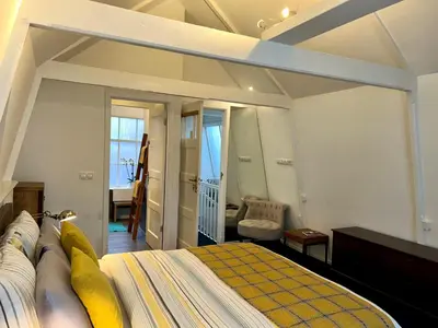 a bedroom with a large bed in a room at Amsterdam 4 Holiday GuestRooms in Amsterdam