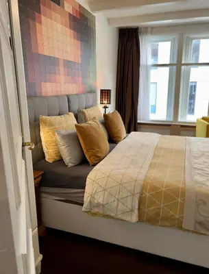 a bedroom with a bed with pillows on it at Amsterdam 4 Holiday GuestRooms in Amsterdam
