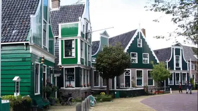 a row of houses with green and white at Noord-Hollands Hof Dream in Spijkerboor