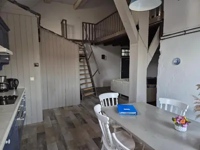 a kitchen with a table and chairs and a staircase at Noord-Hollands Hof Dream in Spijkerboor