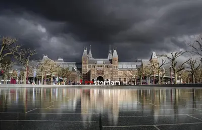 a large building with a reflection in a body of water at FortEdam in Edam