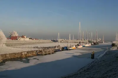 a group of boats are docked in a harbor at FortEdam in Edam