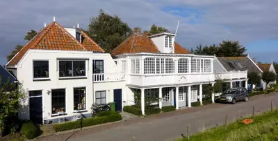 a group of white houses on the side of a street at FortEdam in Edam