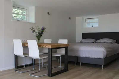 a bedroom with a table and chairs and a bed at FortEdam in Edam