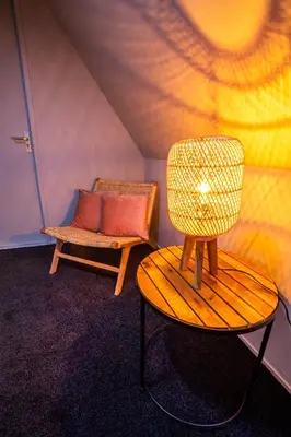 a room with a bench and a chair and a couch at Bambu Sleep Boutique in Haarlem