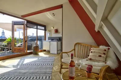 a living room with a chair and a table at Rooftop studio near Amsterdam Castle (Muiden) in Muiden