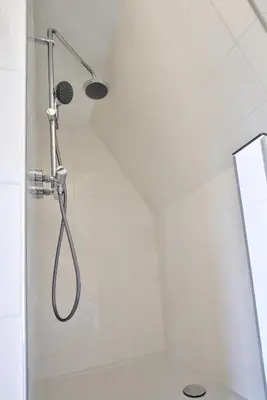 a shower with a shower head in a bathroom at Rooftop studio near Amsterdam Castle (Muiden) in Muiden