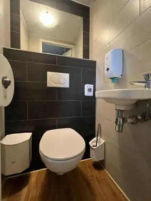 a bathroom with a white toilet and a sink at Amigo Budget Hotel in Amsterdam