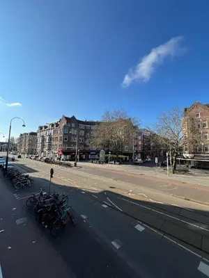 a street with bikes parked on the side of the road at Amigo Budget Hotel in Amsterdam