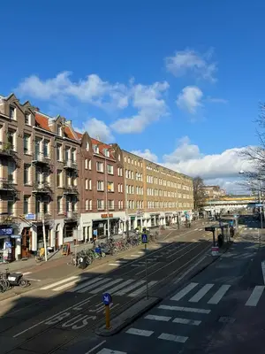 an empty street in a city with buildings at Amigo Budget Hotel in Amsterdam