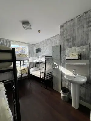 a bathroom with a sink and two bunk beds at Amigo Budget Hotel in Amsterdam