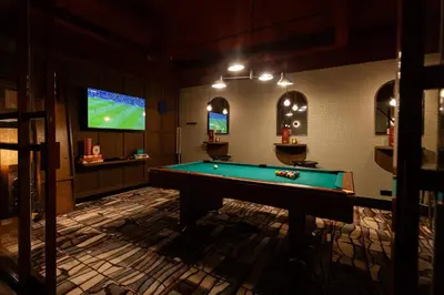 a billiard room with a pool table and a tv at City Hotel Gouda, WorldHotels Crafted Collection in Gouda