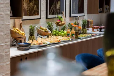 a buffet with plates of food on a table at City Hotel Gouda, WorldHotels Crafted Collection in Gouda