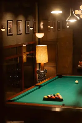 a room with a pool table and a lamp at City Hotel Gouda, WorldHotels Crafted Collection in Gouda