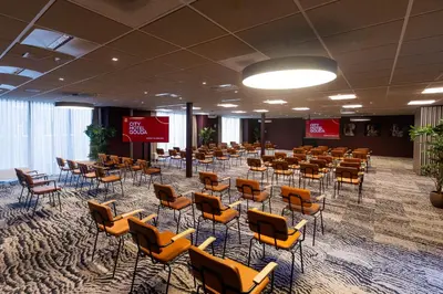 a room with rows of chairs and tables in it at City Hotel Gouda, WorldHotels Crafted Collection in Gouda